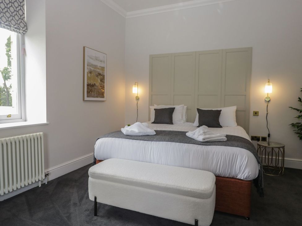 A bedroom with a bed and decorative pillows at Brettargh Holt Mansion 32 near Levens