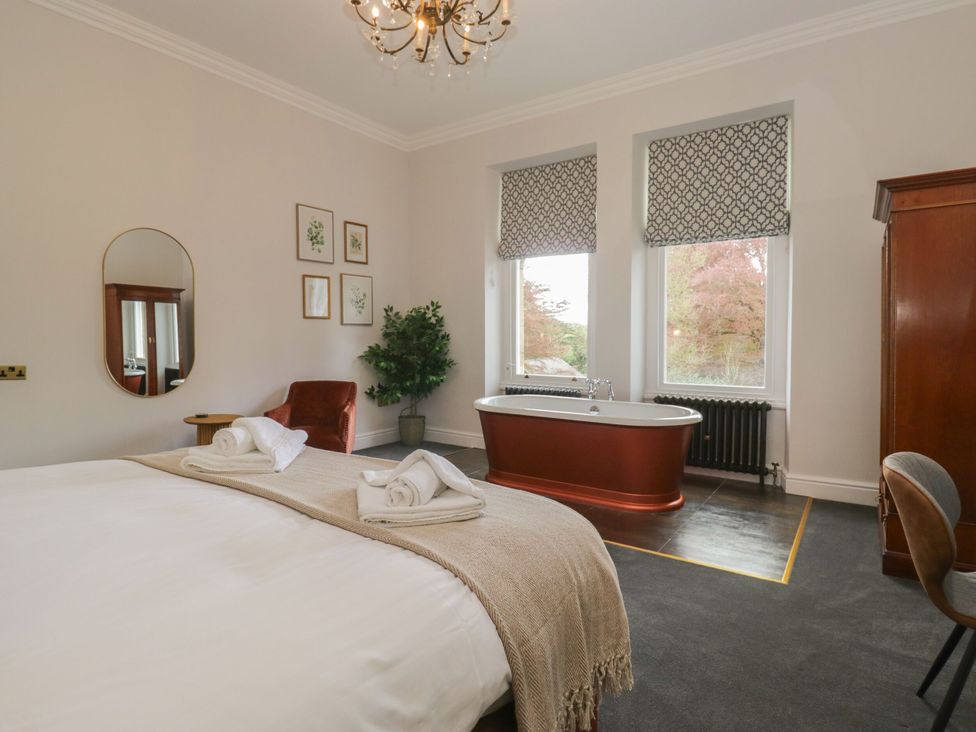 A bedroom with a bed and bathtub at Brettargh Holt Mansion 32 near Levens