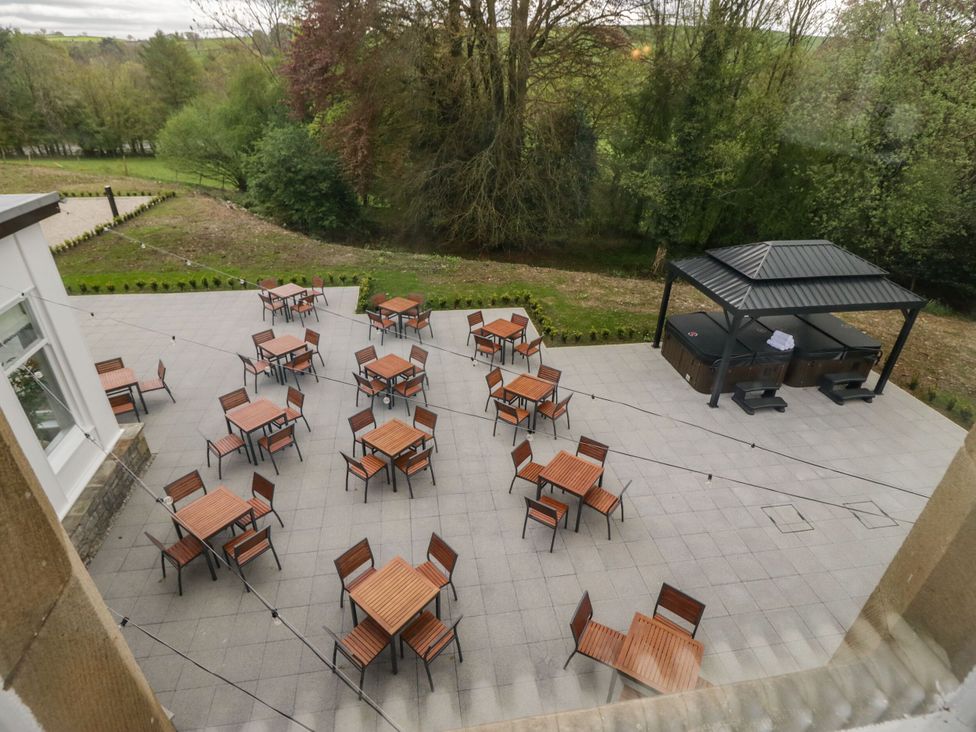An outdoor area with tables and chairs at Brettargh Holt Mansion 32 near Levens