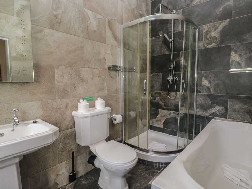 A bathroom with a sink, toilet, shower, and bathtub at Brettargh Holt Mansion 32 near Levens