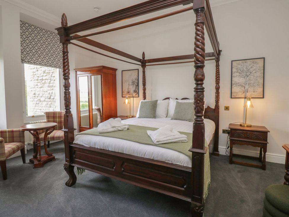 A bedroom with a four-poster bed and a wardrobe at Brettargh Holt Mansion 32 near Levens