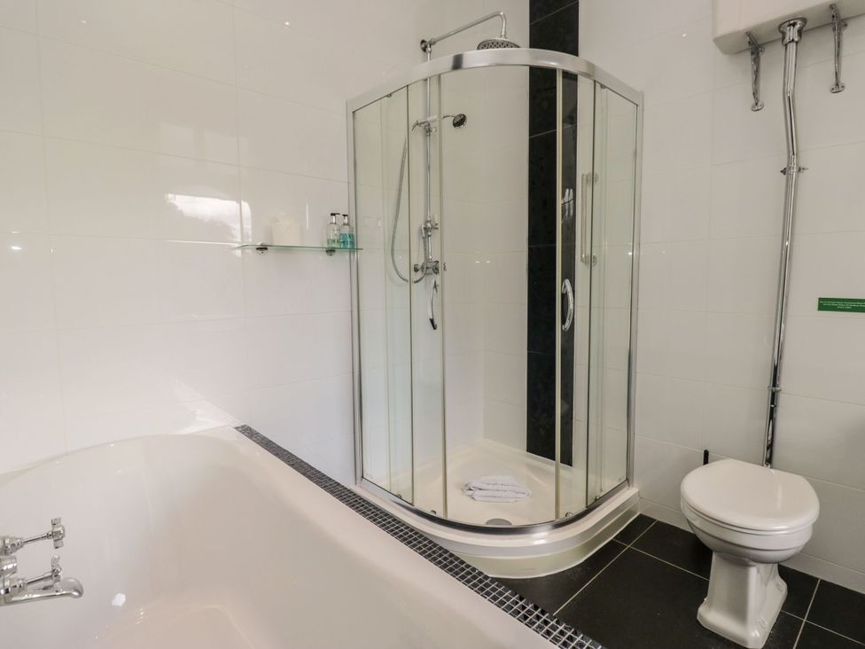 A bathroom with a shower enclosure, bathtub, and toilet at Brettargh Holt Mansion 32 near Levens