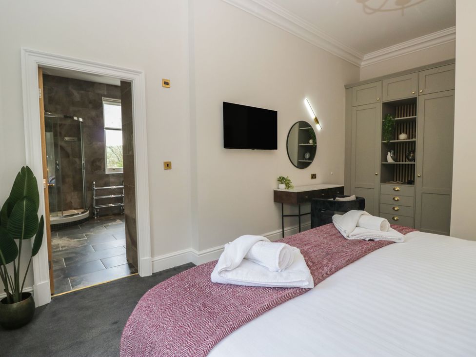 A bedroom with a bed and towels at Brettargh Holt Mansion 32 near Levens