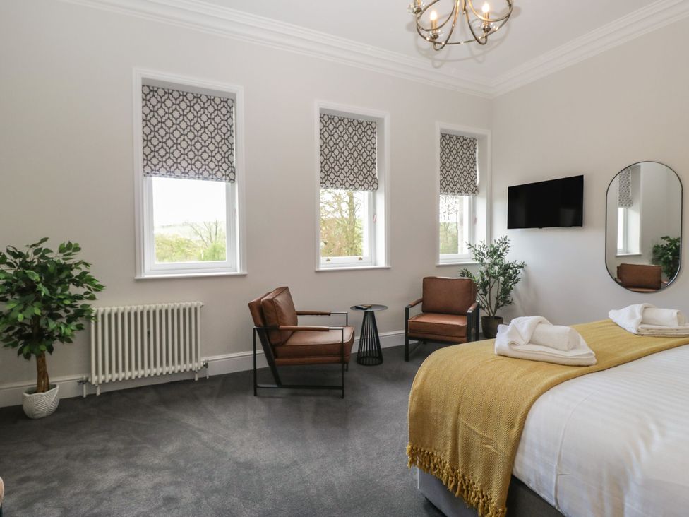 A bedroom with a bed and seating area at Brettargh Holt Mansion 32 near Levens