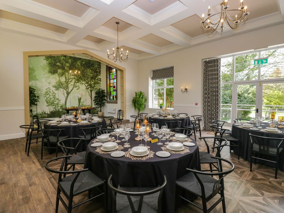 A dining room with tables set for a meal at Brettargh Holt Mansion 32 near Levens