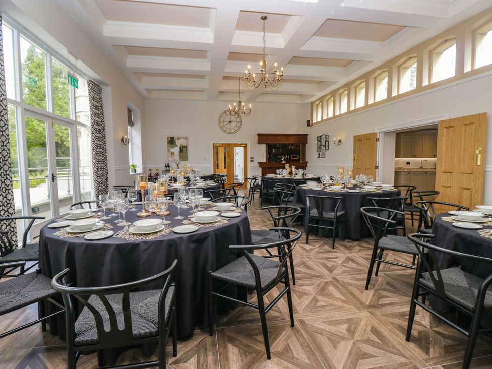 A dining room set for a meal with tables and chairs at Brettargh Holt Mansion 32 near Levens