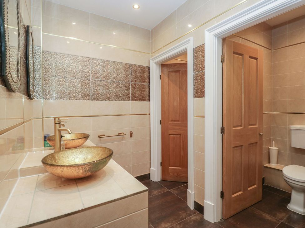 A bathroom with sinks and toilet at Brettargh Holt Mansion 32 near Levens