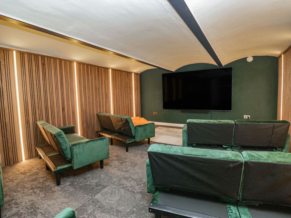 A home theater with sofas and a television at Brettargh Holt Mansion 32 near Levens