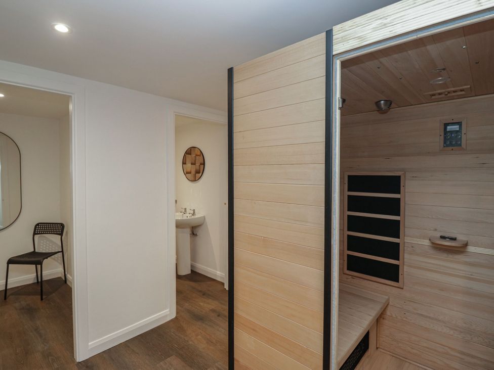 A bathroom with a sink, mirror, and sauna at Brettargh Holt Mansion 32 near Levens