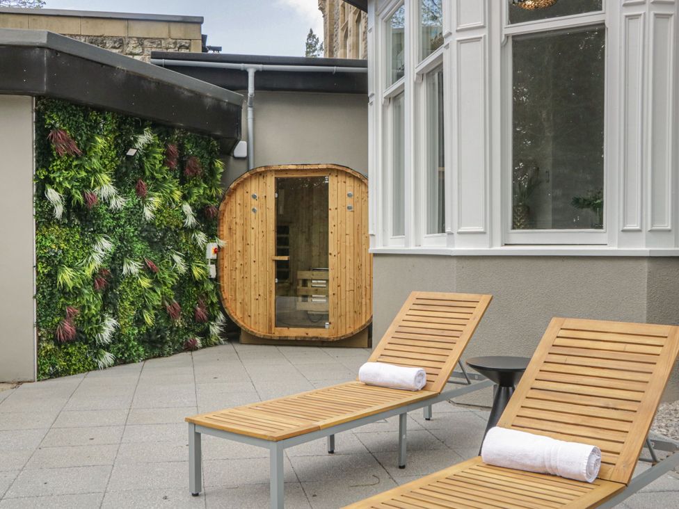 An outdoor area with sun loungers and a sauna at Brettargh Holt Mansion 32 near Levens