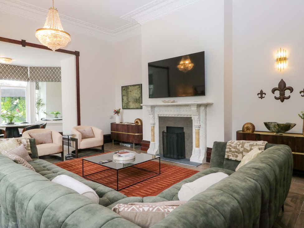 A living room with a sofa, coffee table, and fireplace at Brettargh Holt Mansion Sleeping 32 near Sizergh, Cumbria