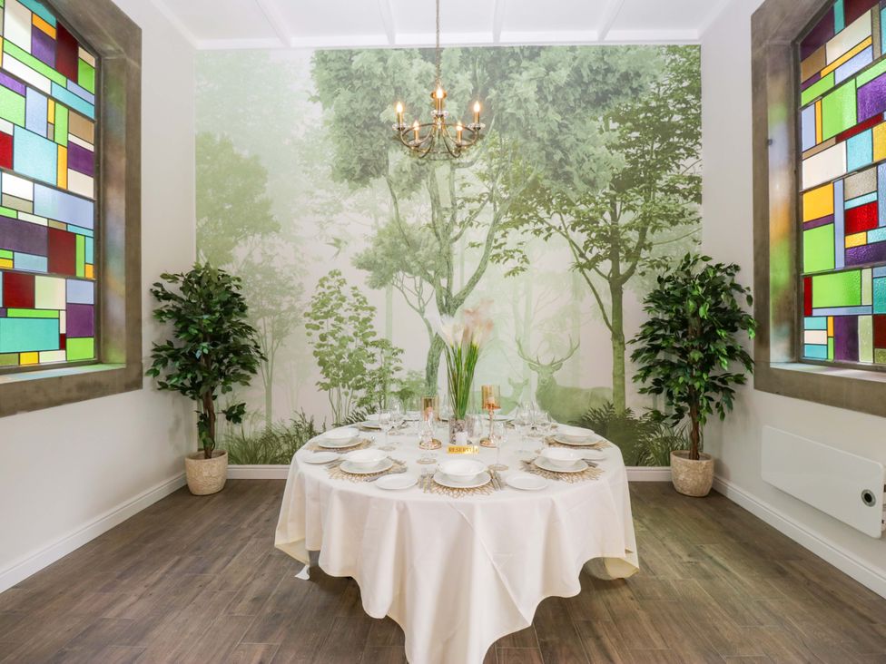 A dining room with a table set for dinner at Brettargh Holt Mansion Sleeping 32 near Sizergh, Cumbria