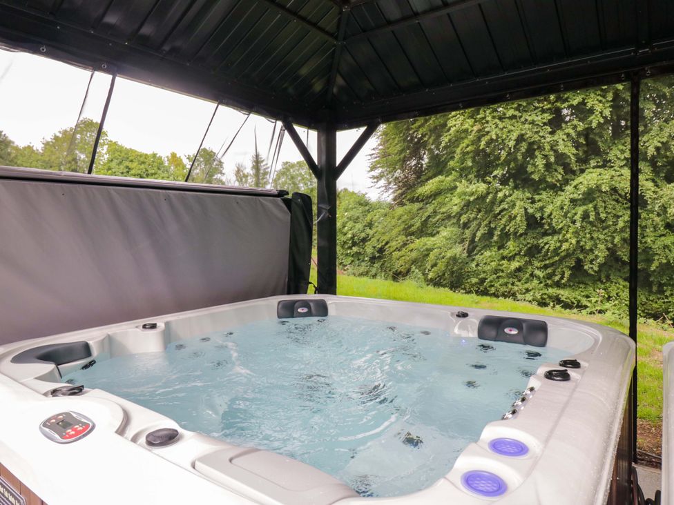 A hot tub with water in a covered structure at Brettargh Holt Mansion Sleeping 32 near Sizergh, Cumbria