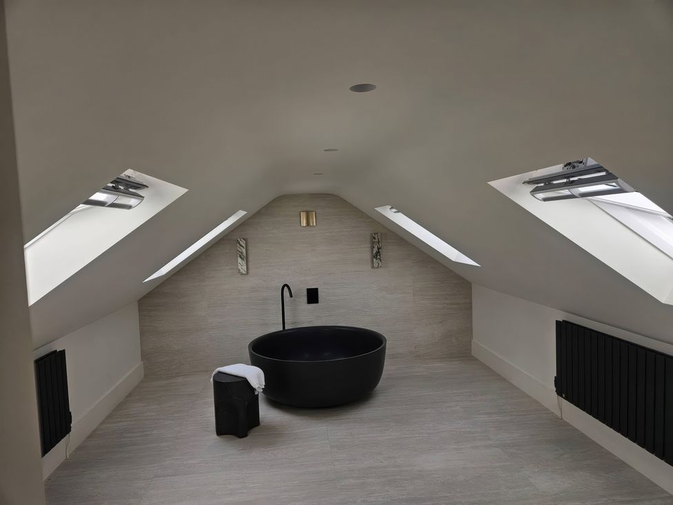 A bathroom with a bathtub and towel at Brynseion Uchaf in Aberystwyth