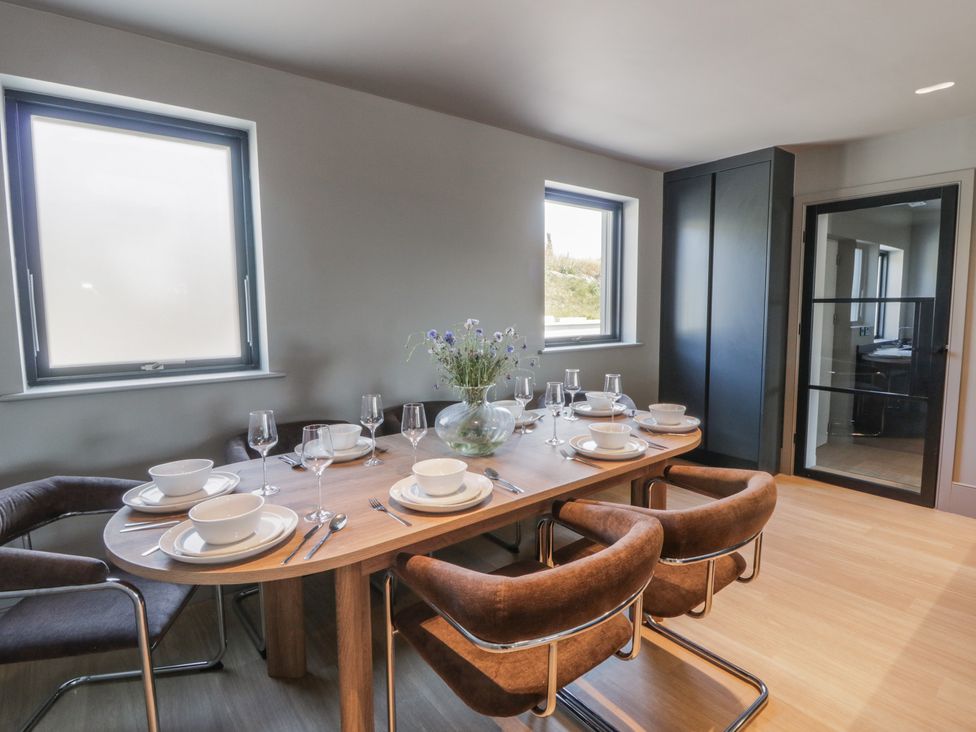 A dining room with a table set for a meal at Brynseion Uchaf near Aberystwyth