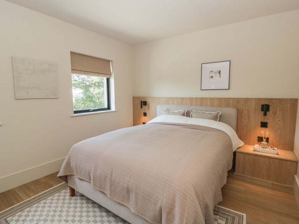 A bedroom with a bed and nightstand at Brynseion Uchaf near Aberystwyth