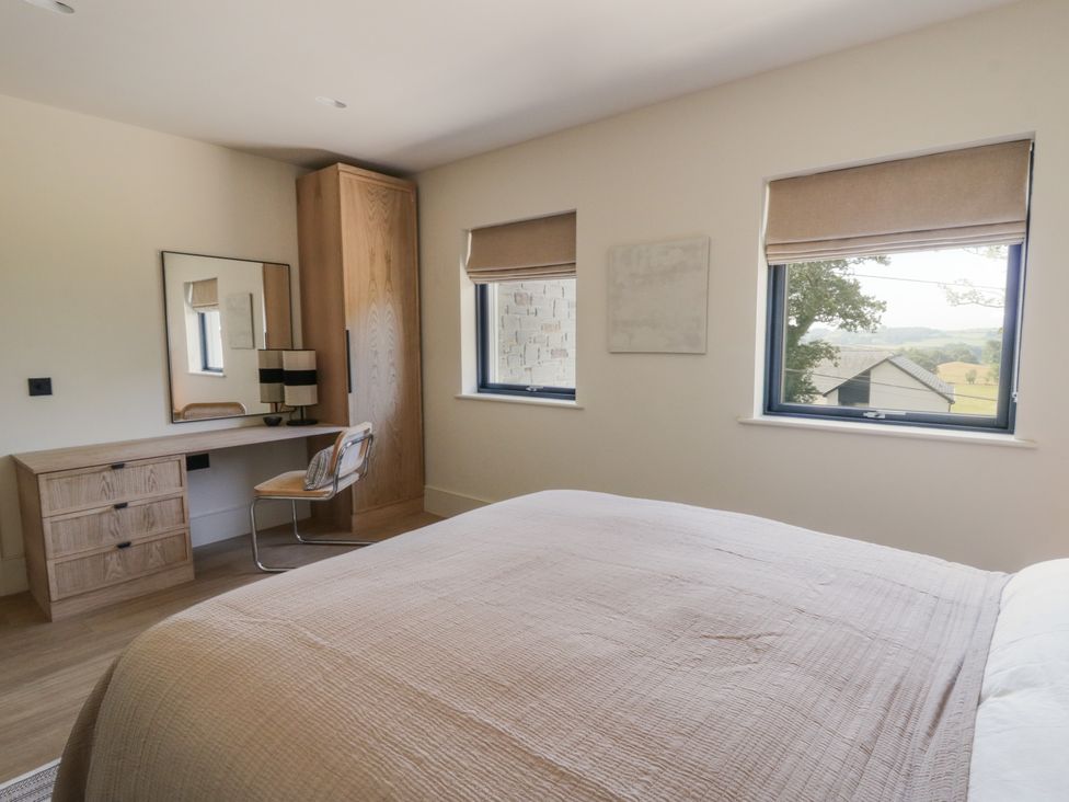 A bedroom with a bed and desk at Brynseion Uchaf near Aberystwyth