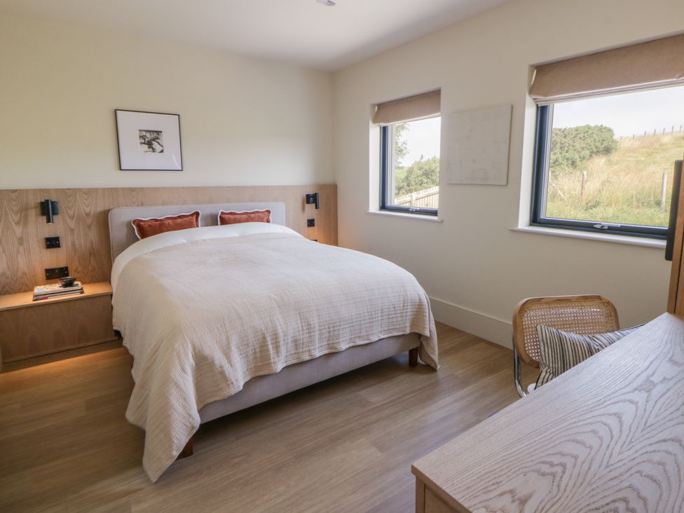 A bedroom with a bed and a desk at Brynseion Uchaf near Aberystwyth