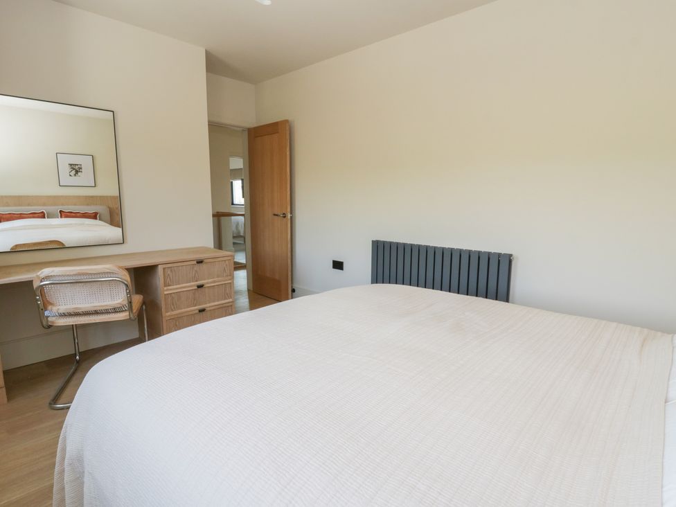 A bedroom with a bed and a desk at Brynseion Uchaf near Aberystwyth