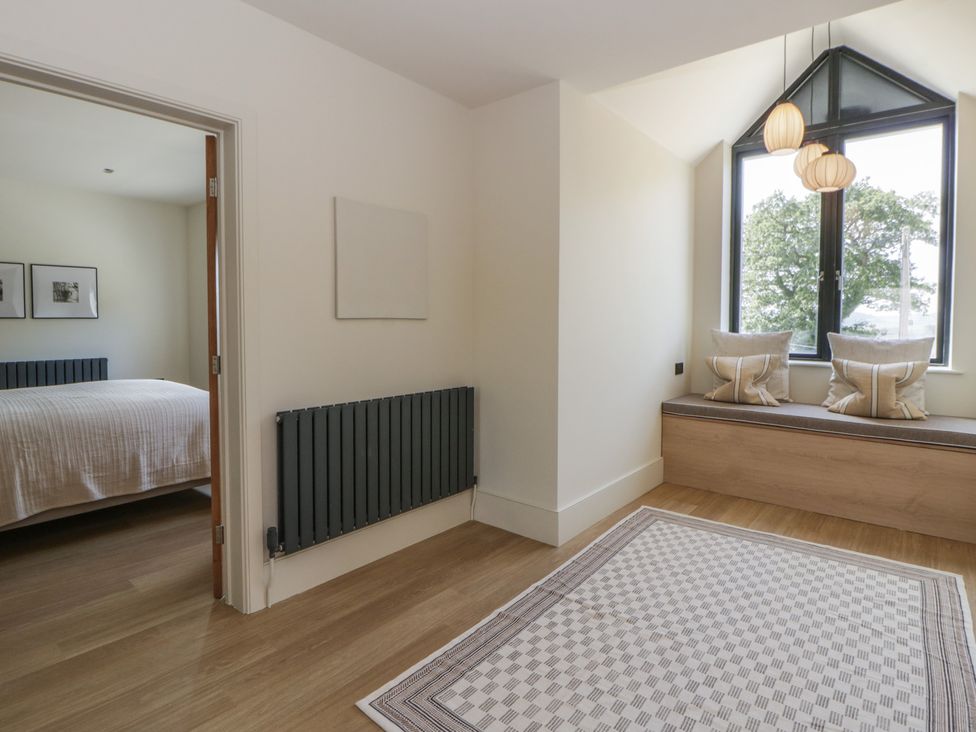 A bedroom with a bed and window seat at Brynseion Uchaf near Aberystwyth