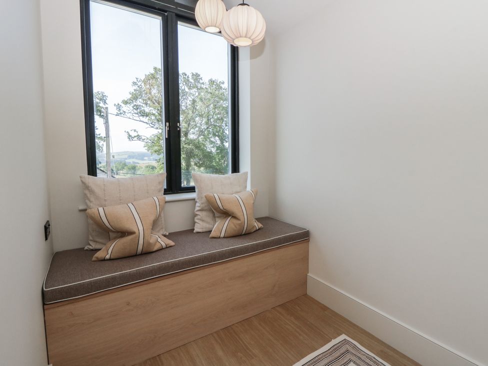 A snug with a window seat and cushions at Brynseion Uchaf near Aberystwyth
