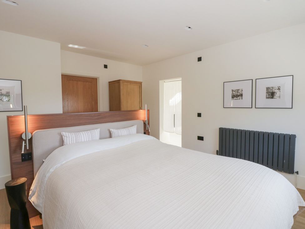 A bedroom with a bed and wardrobe at Brynseion Uchaf near Aberystwyth