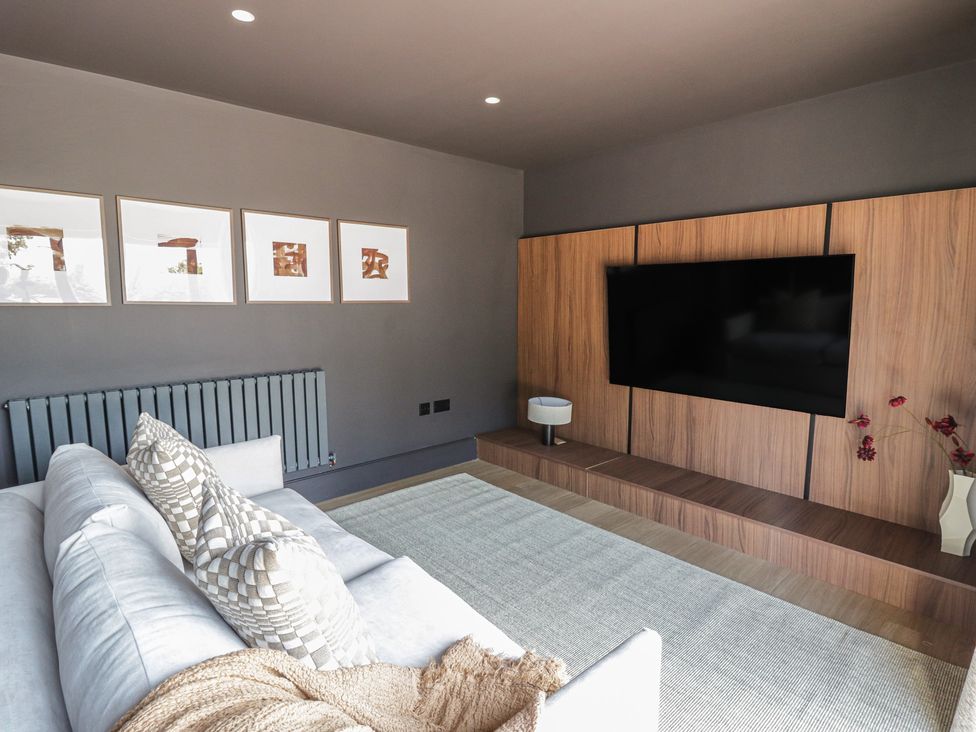 A living room with a television and sofa at Brynseion Uchaf near Aberystwyth