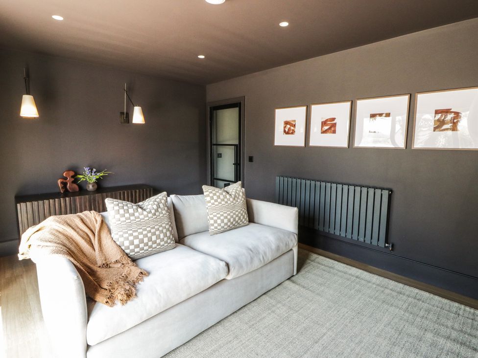 A living room with a sofa and wall art at Brynseion Uchaf near Aberystwyth