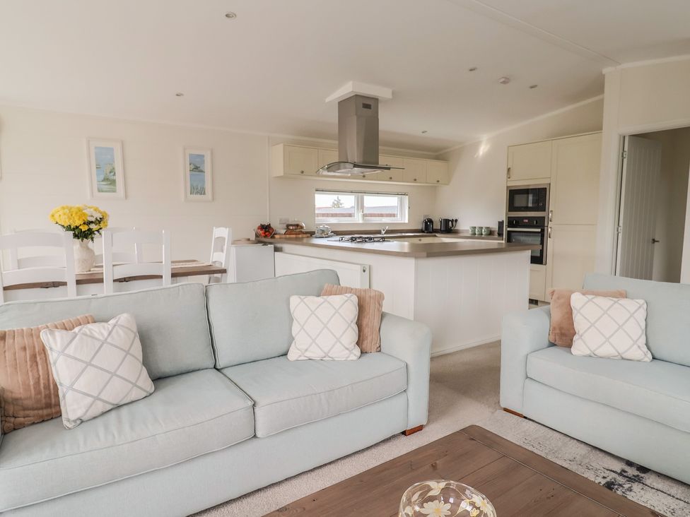 A living room with a sofa and dining area at Hazelwood 3 Pinewood Retreat in Rousdon near Lyme Regis