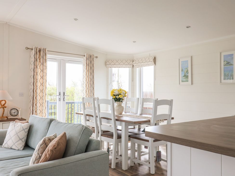 A dining room with a table and chairs at Hazelwood 3 in Pinewood Retreat in Rousdon near Lyme Regis