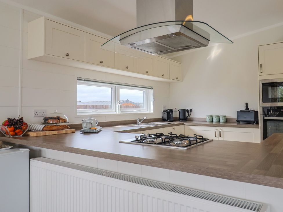 A kitchen with gas stove and appliances at Hazelwood 3 Pinewood Retreat in Rousdon near Lyme Regis