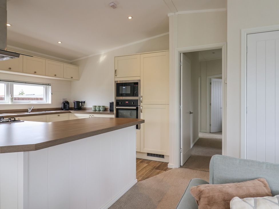 A kitchen with appliances and cabinetry at Hazelwood 3 in Pinewood Retreat in Rousdon near Lyme Regis