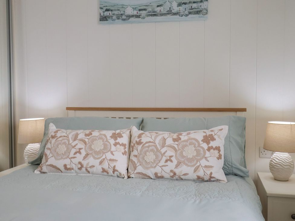 A bedroom with a bed and pillows at Hazelwood 3, Pinewood Retreat in Rousdon near Lyme Regis