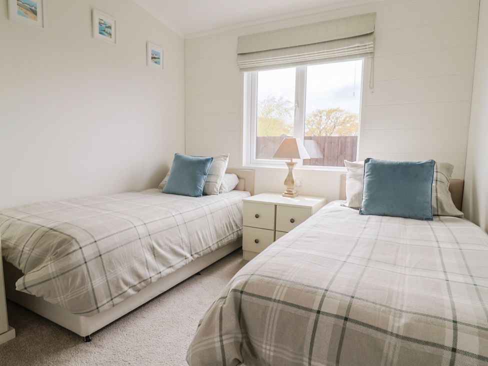 A bedroom with two single beds and a window at Hazelwood 3, Pinewood Retreat in Rousdon near Lyme Regis
