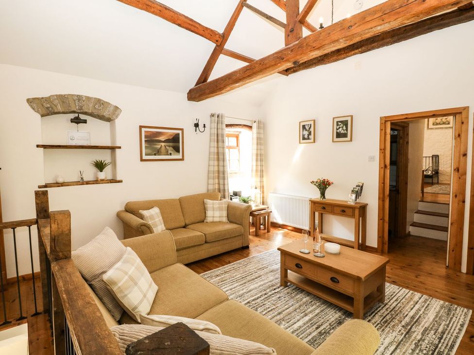 A living room with a sofa and a coffee table at The Barn in 