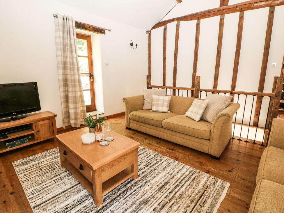 A living room with a sofa and coffee table at The Barn 