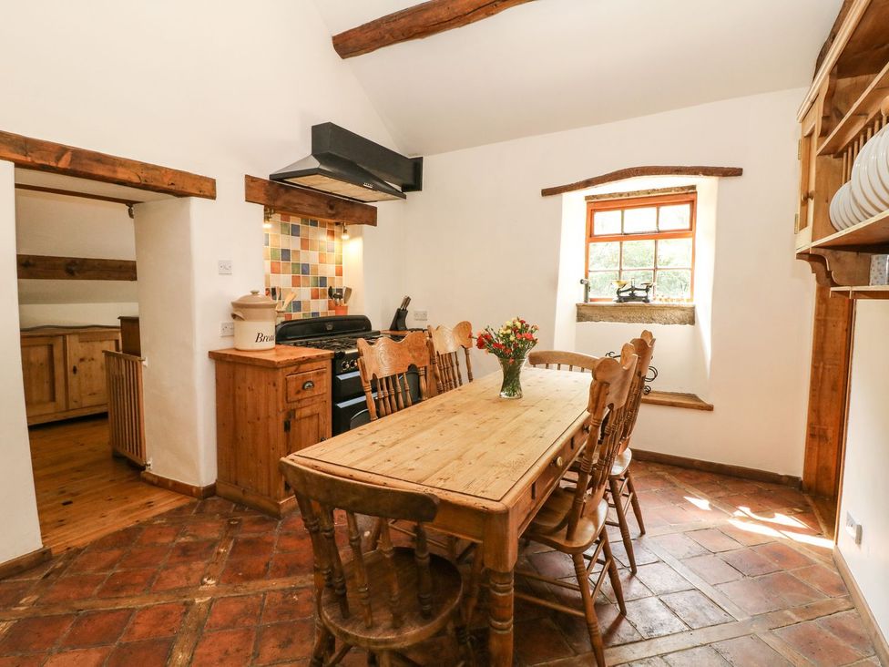 A kitchen with a dining table and chairs at The Barn in 