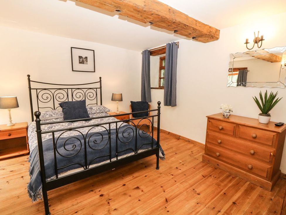 A bedroom with a bed and furniture at The Barn in 