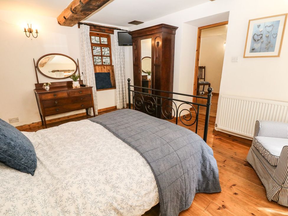 A bedroom with a bed and dresser at The Barn in 