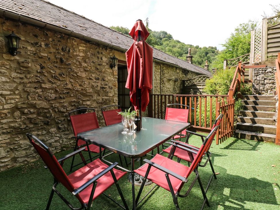 An outdoor seating area with a table and chairs at The Barn