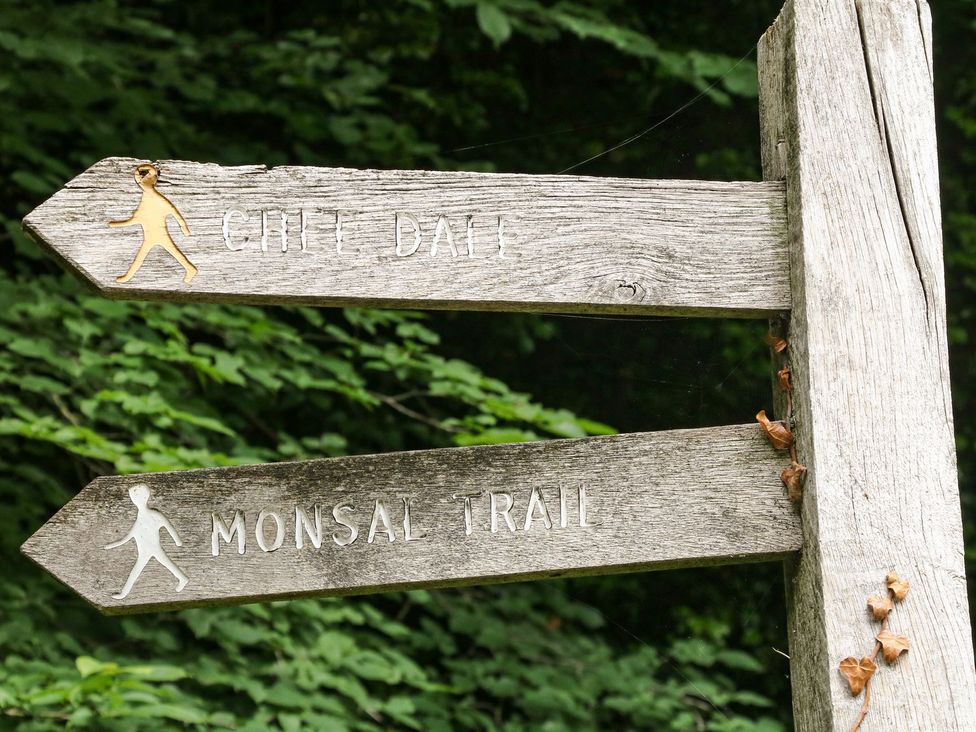 A wooden signpost indicating Chelm Dale and Monsal Trail