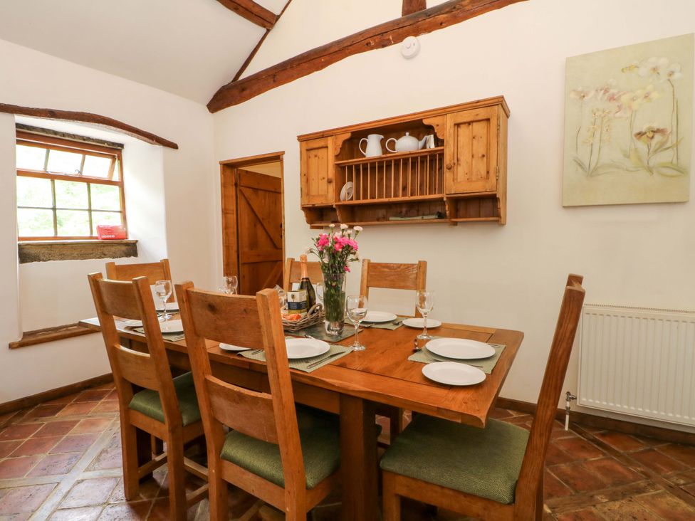 A dining room with a wooden table and chairs at The Barn in Miller's Dale near Tideswell