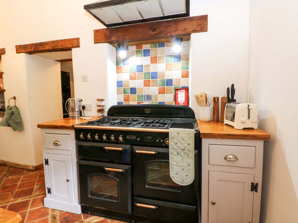 A kitchen with an oven, toaster, and utensils at The Barn in Miller's Dale near Tideswell