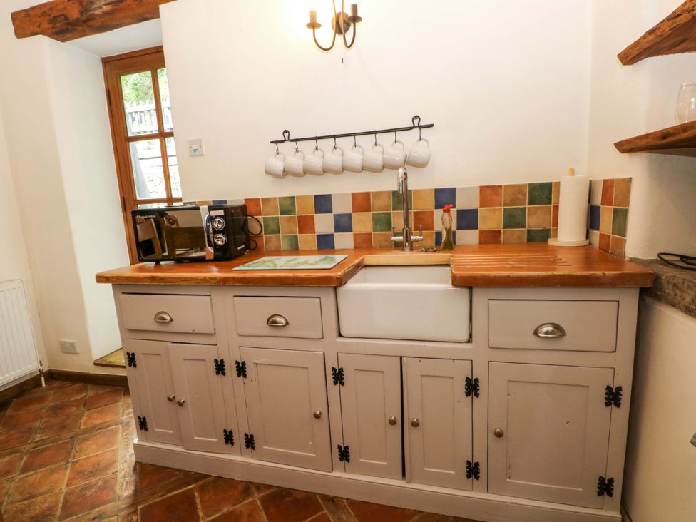 A kitchen with cabinets and sink at The Barn in Miller's Dale near Tideswell