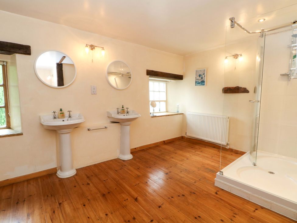 A bathroom with two sinks and a shower at The Barn in Miller's Dale near Tideswell
