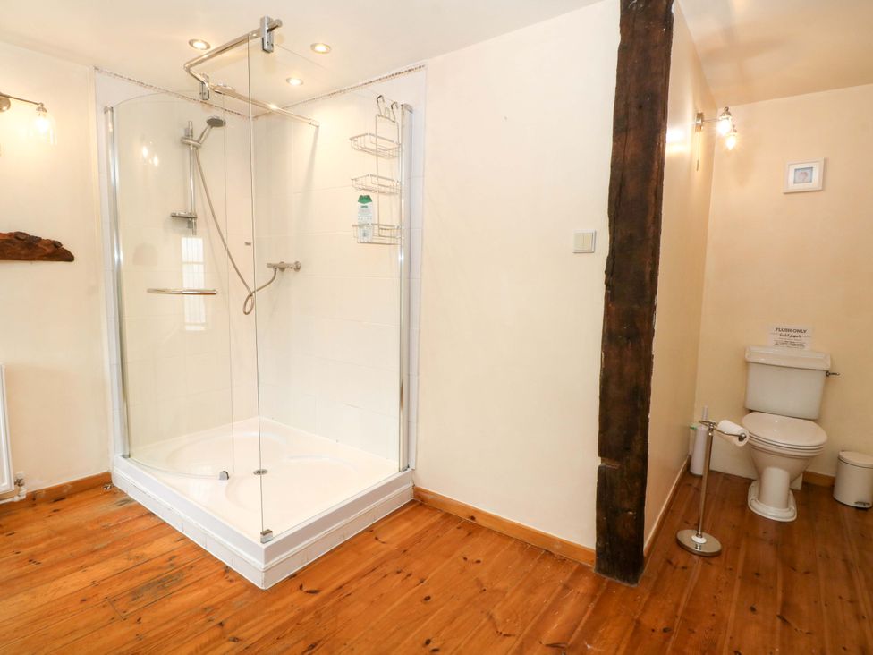 A bathroom with a shower and toilet at The Barn in Miller's Dale near Tideswell
