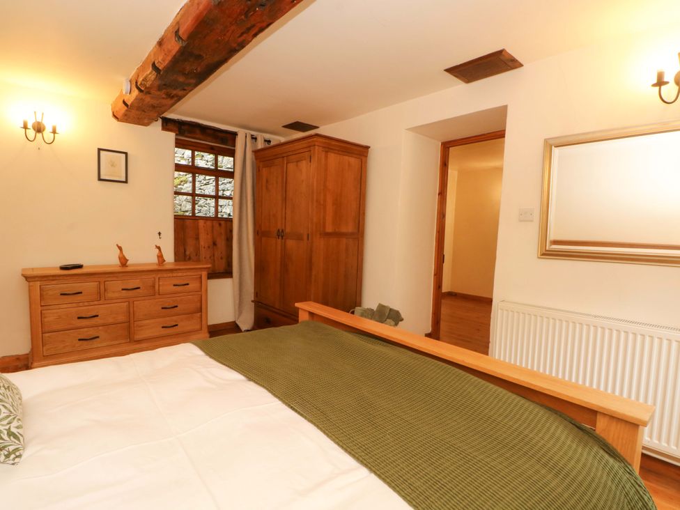 A bedroom with wooden furniture at The Barn in Miller's Dale near Tideswell