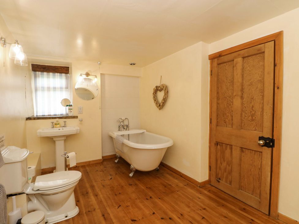 A bathroom with a bathtub and sink at The Barn in Miller's Dale near Tideswell
