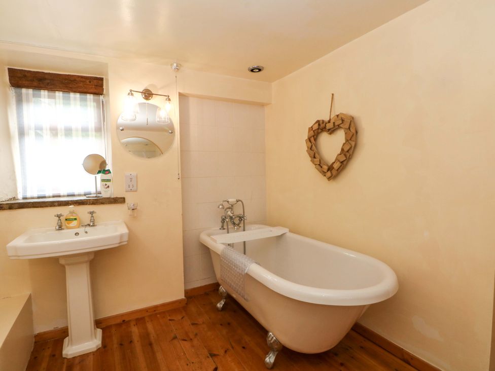 A bathroom with a bathtub and sink at The Barn in Miller's Dale near Tideswell