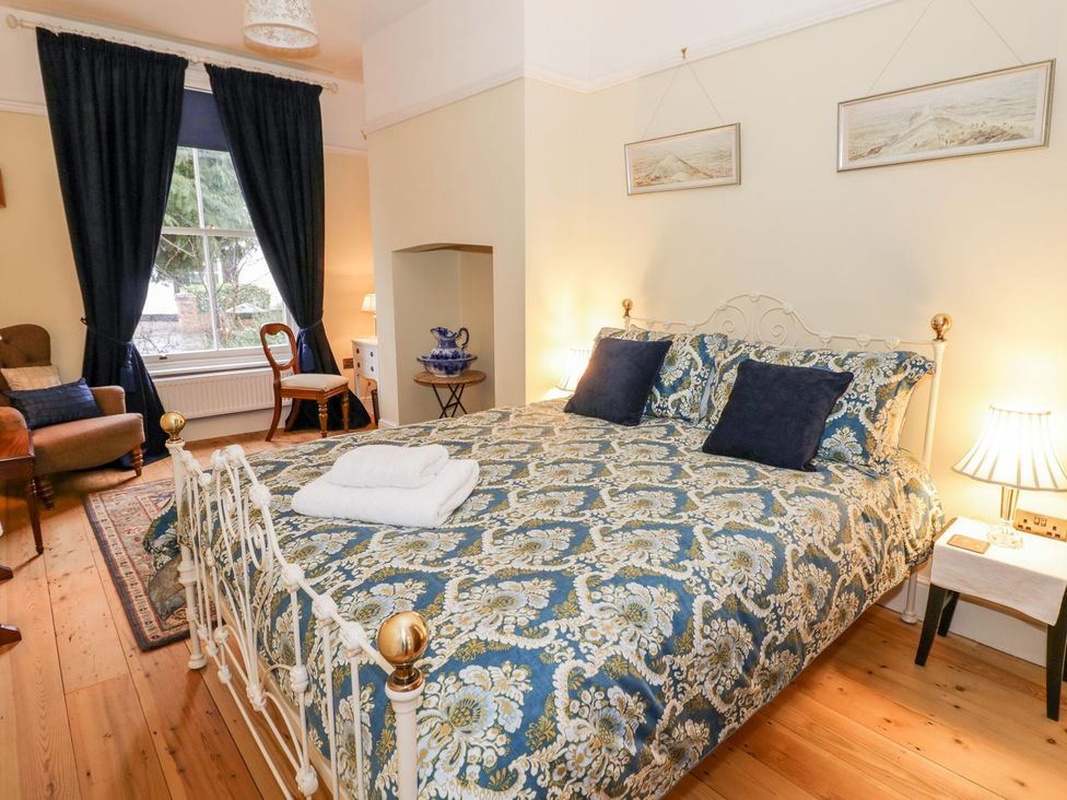 A bedroom with a double bed and armchair at Little Mornington in Malvern